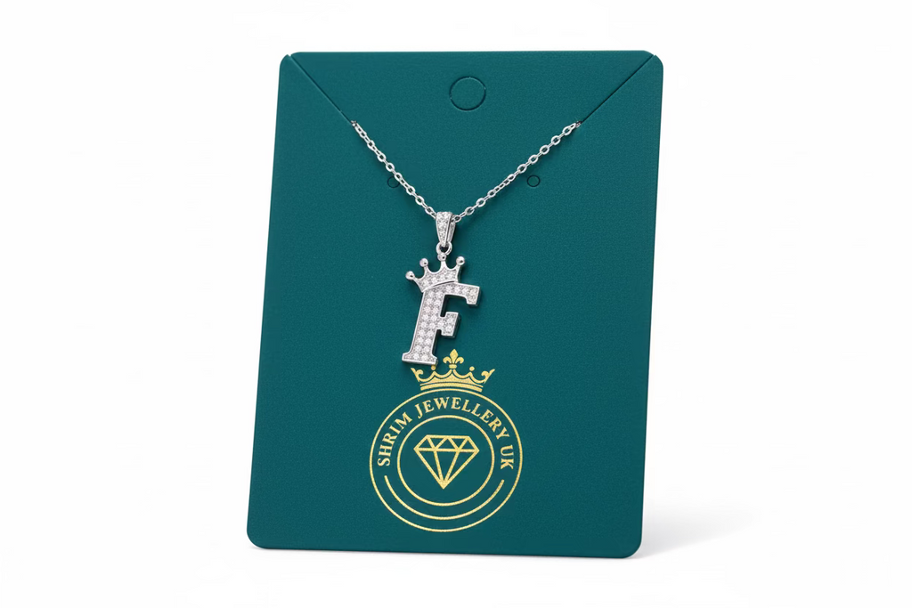 Necklace with a pendant on a green card with 'Follow Us' text.